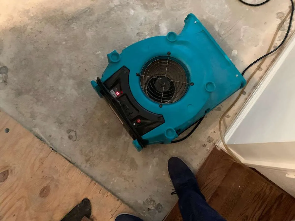 Air mover drying subfloor during Commercial Water Damage Restoration in North Miami
